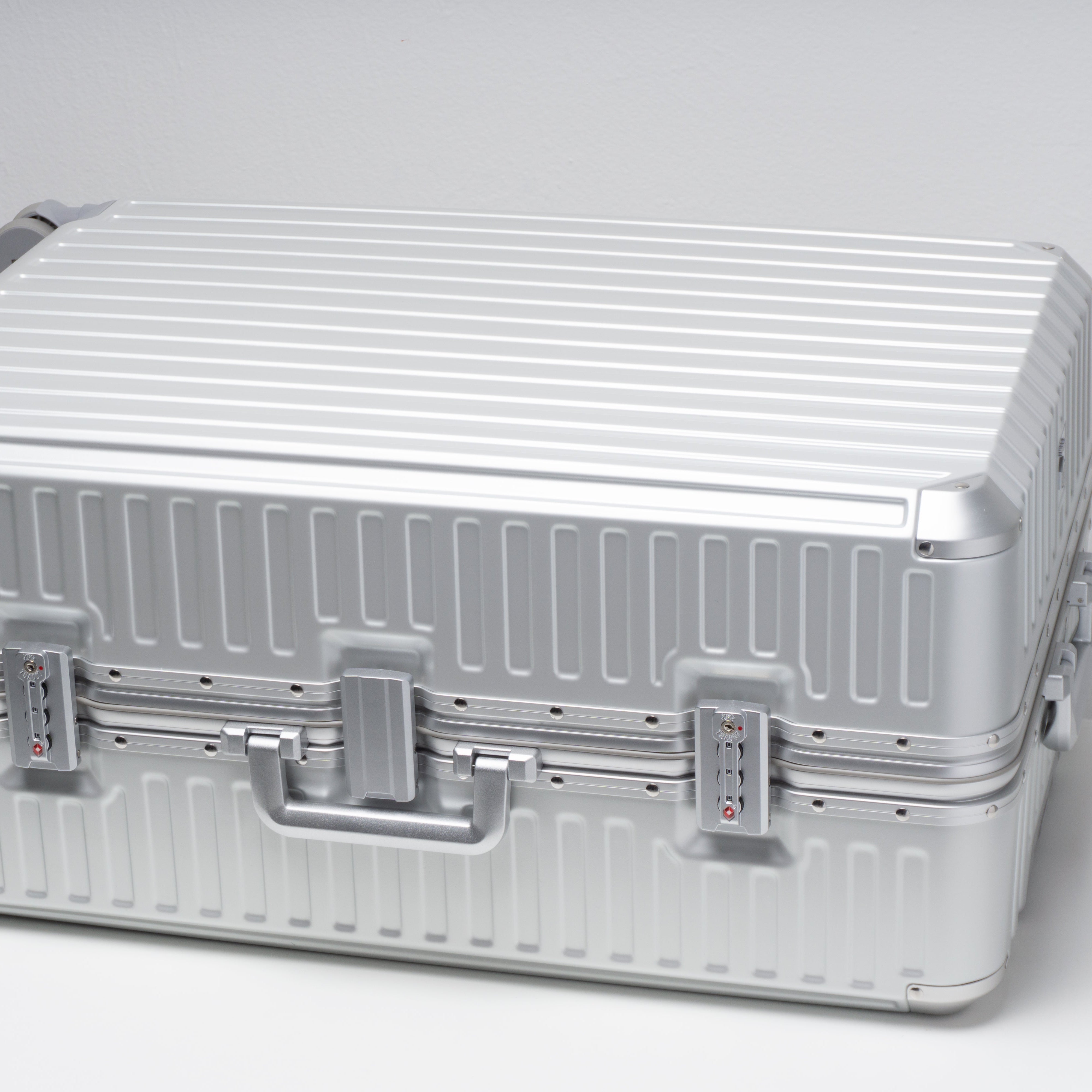 Silver suitcase on a white background