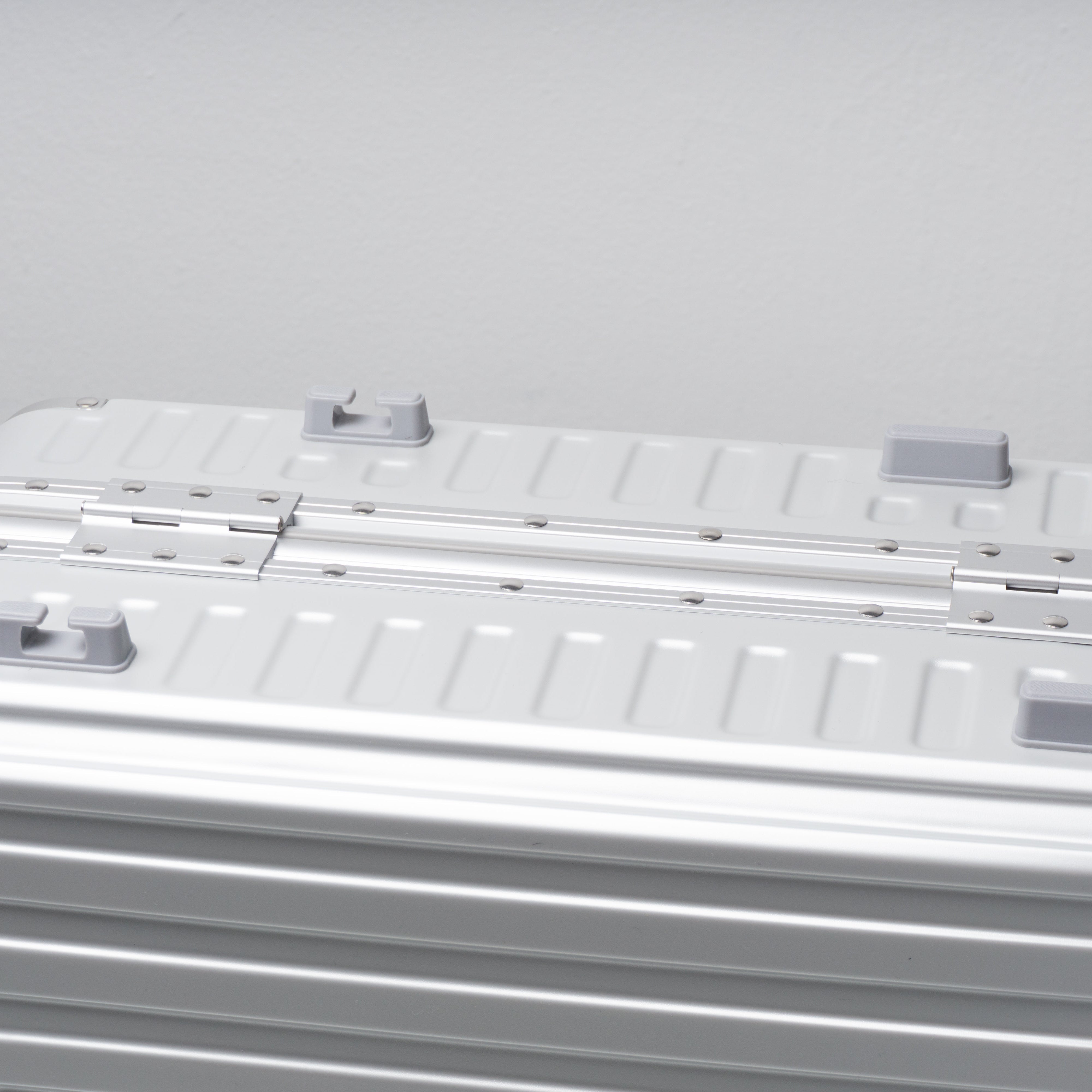 Silver suitcase on a light gray background